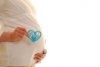 4643514-pregnant-woman-profile-holding-heart-that-says-baby.jpg